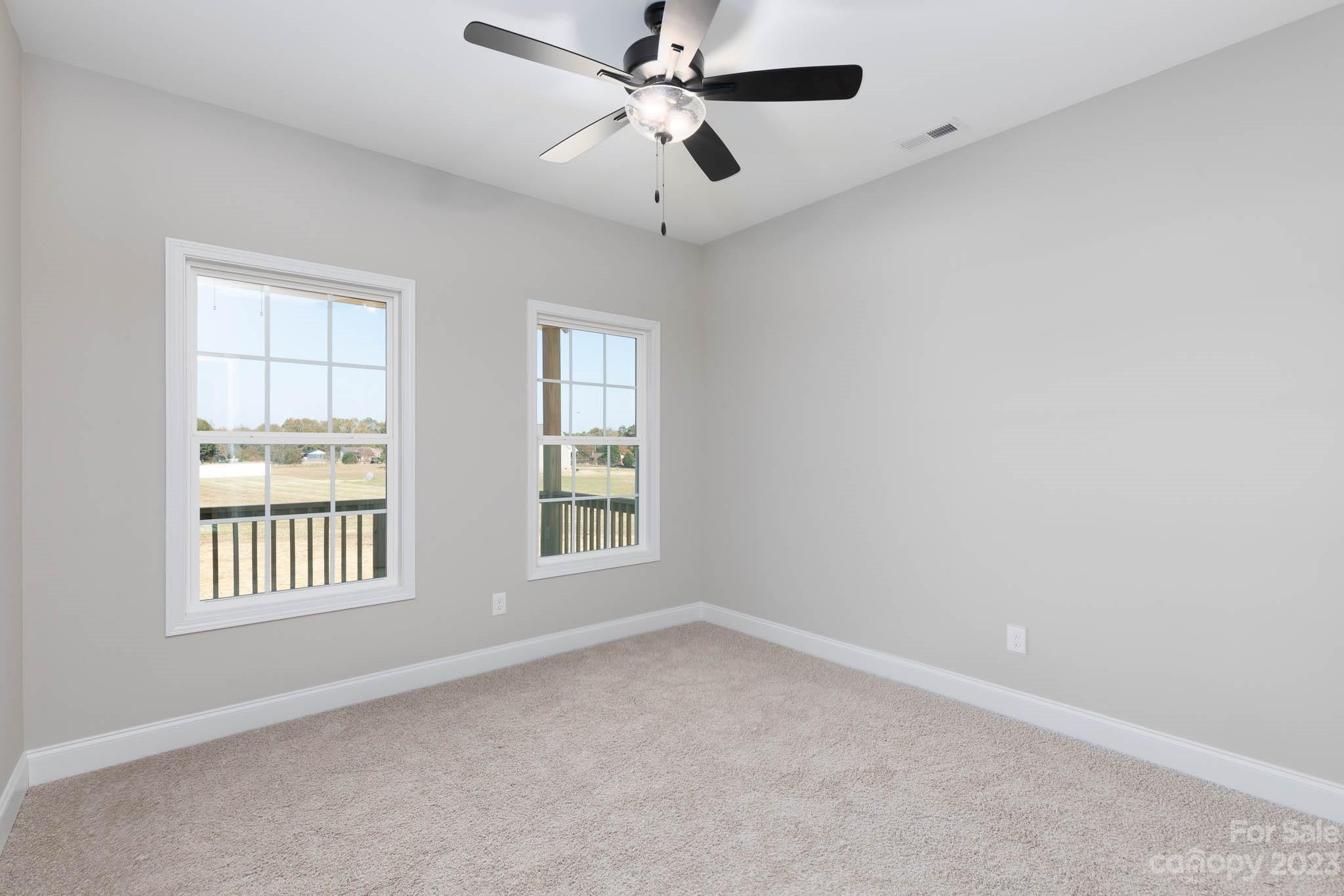 4639 Simpson Road Edgemoor, SC 29712 - Photo 17 of 30 an empty room with windows and ceiling fan