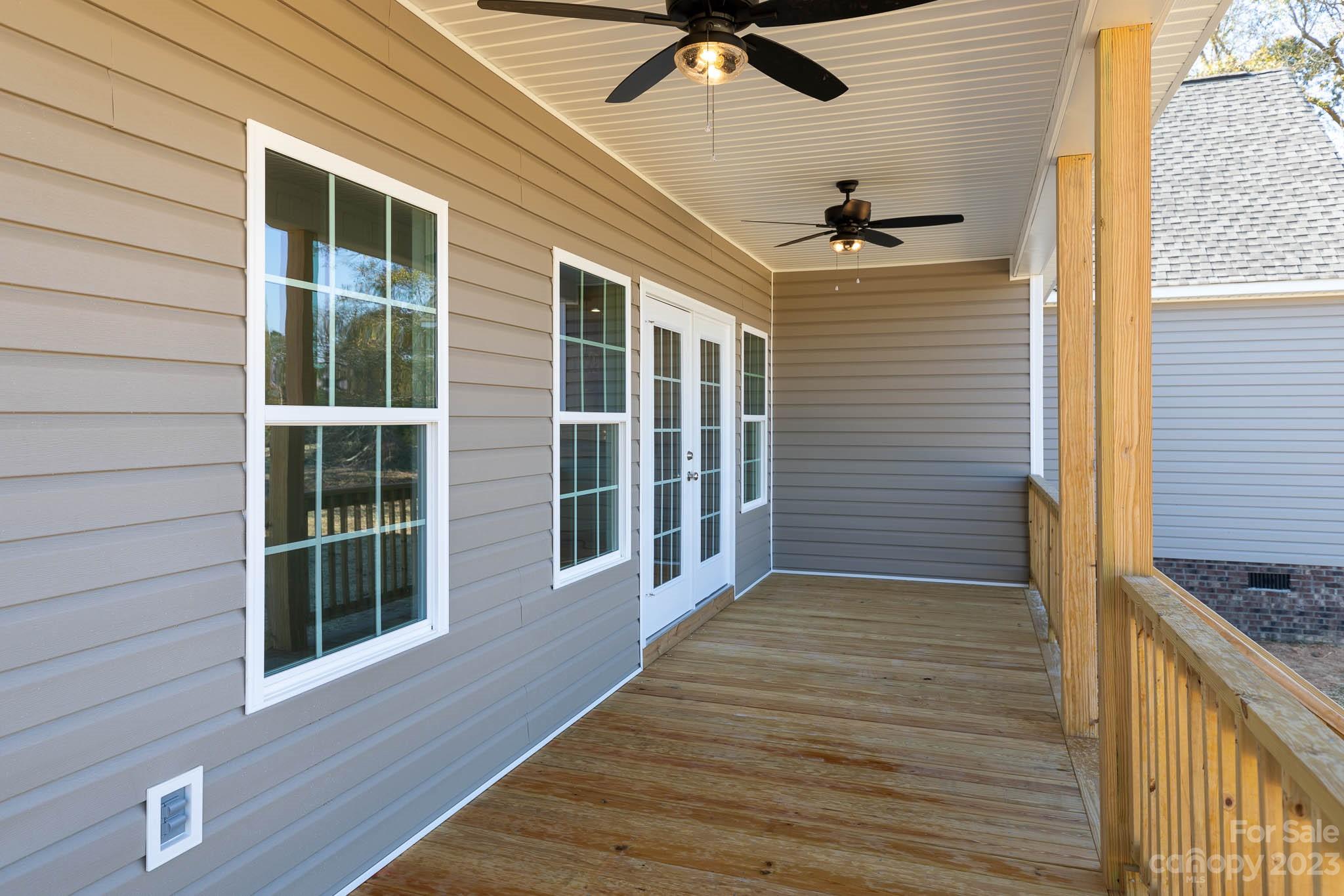 4639 Simpson Road Edgemoor, SC 29712 - Photo 18 of 30 a view of a porch with wooden floor and a ceiling fan