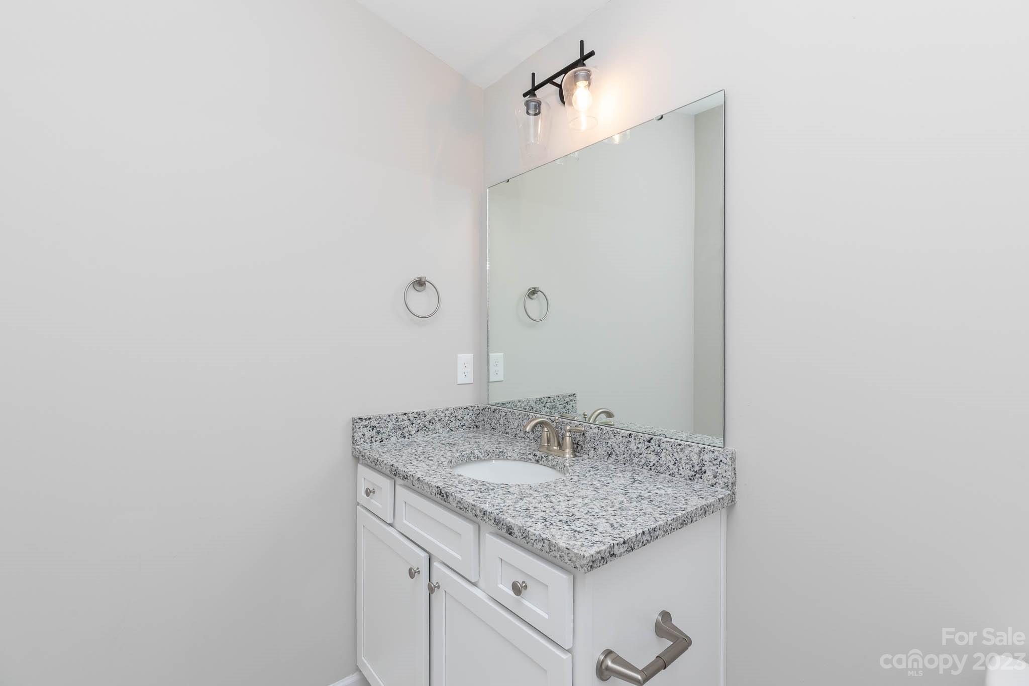 4639 Simpson Road Edgemoor, SC 29712 - Photo 21 of 30 a bathroom with a granite countertop sink and a mirror