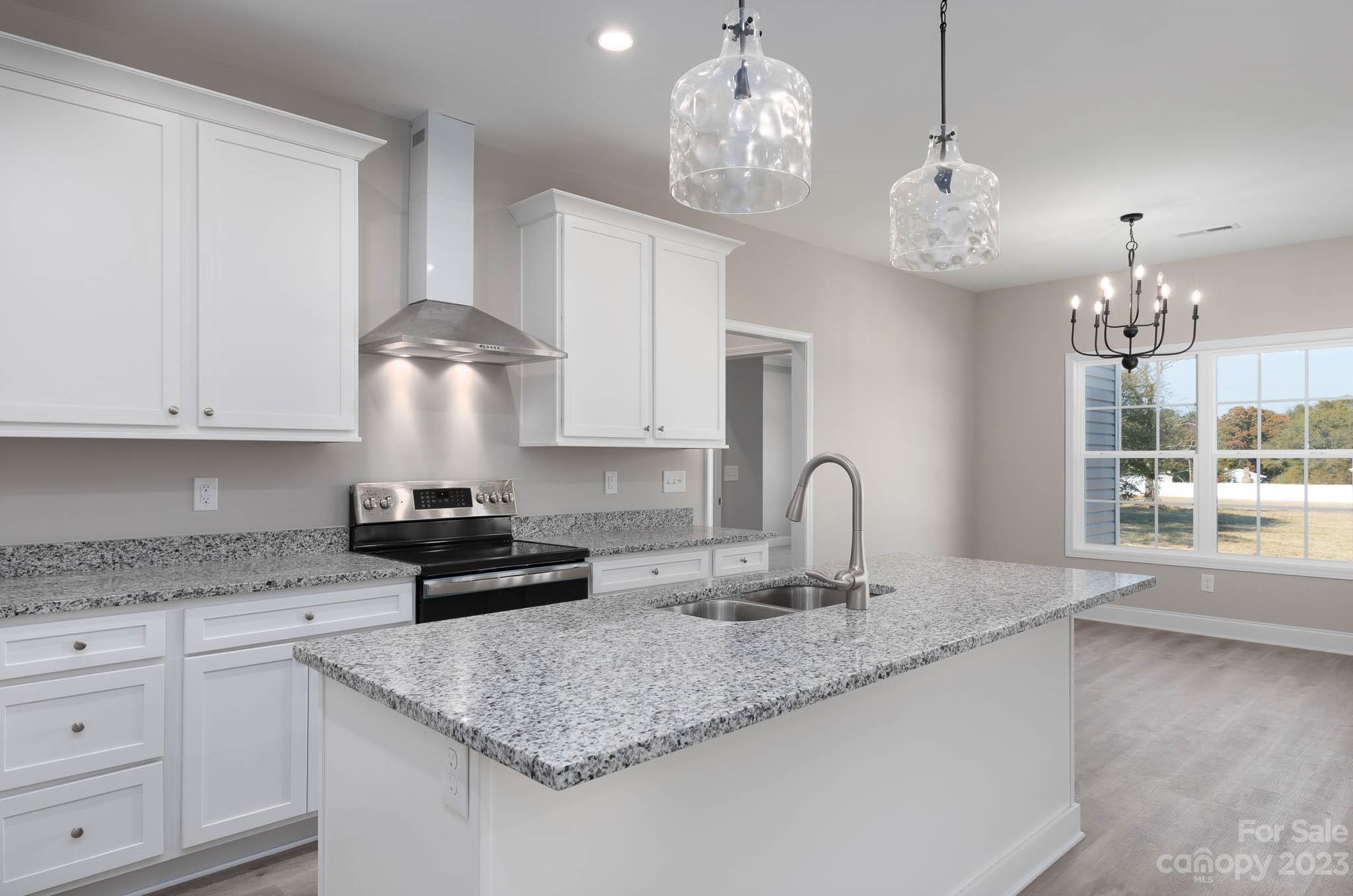 4639 Simpson Road Edgemoor, SC 29712 - Photo 23 of 30 a kitchen with kitchen island granite countertop stainless steel appliances a sink stove and cabinets