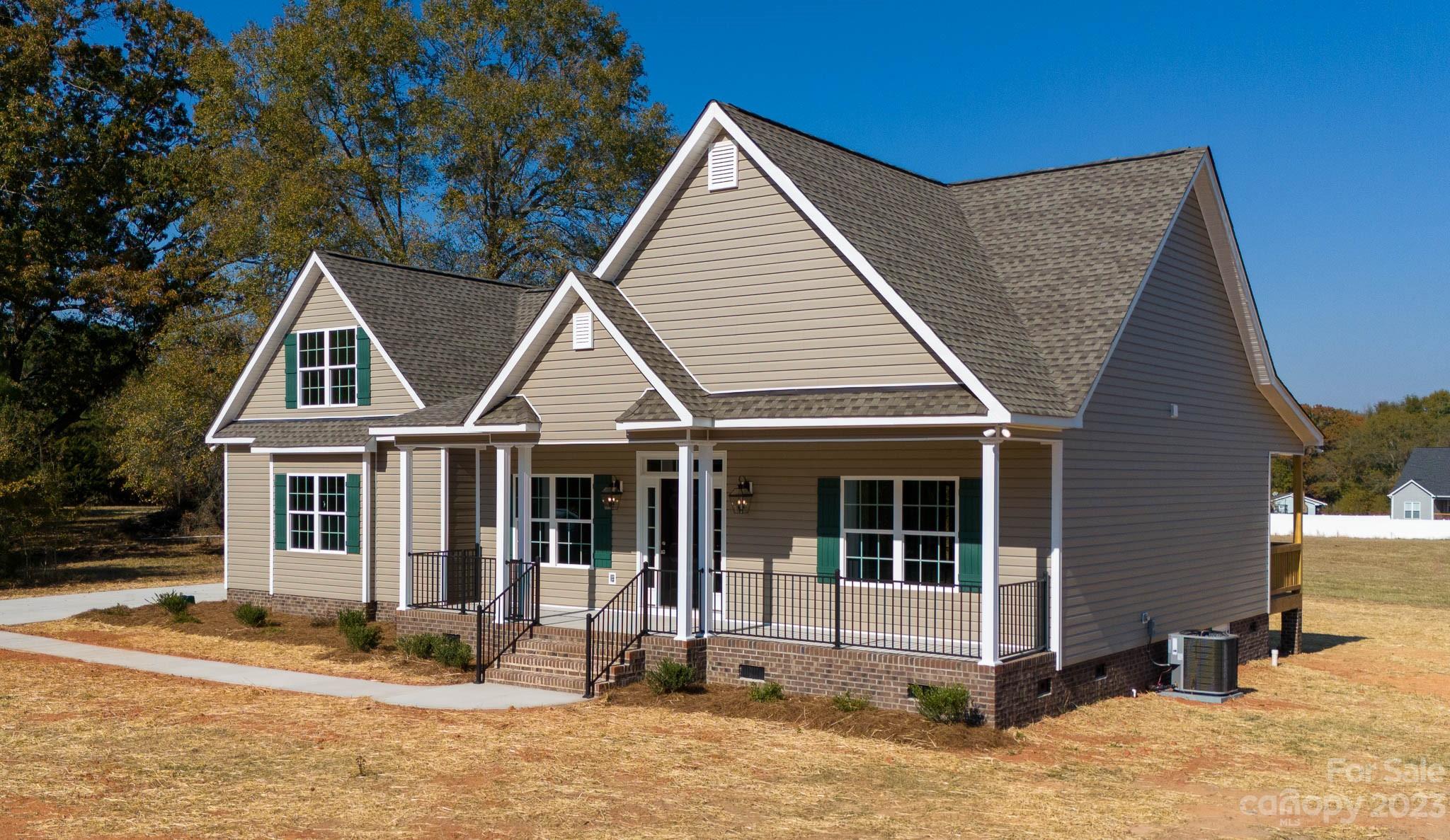 4639 Simpson Road Edgemoor, SC 29712 - Photo 24 of 30 a view of small white house with a large window potted plants and large tree