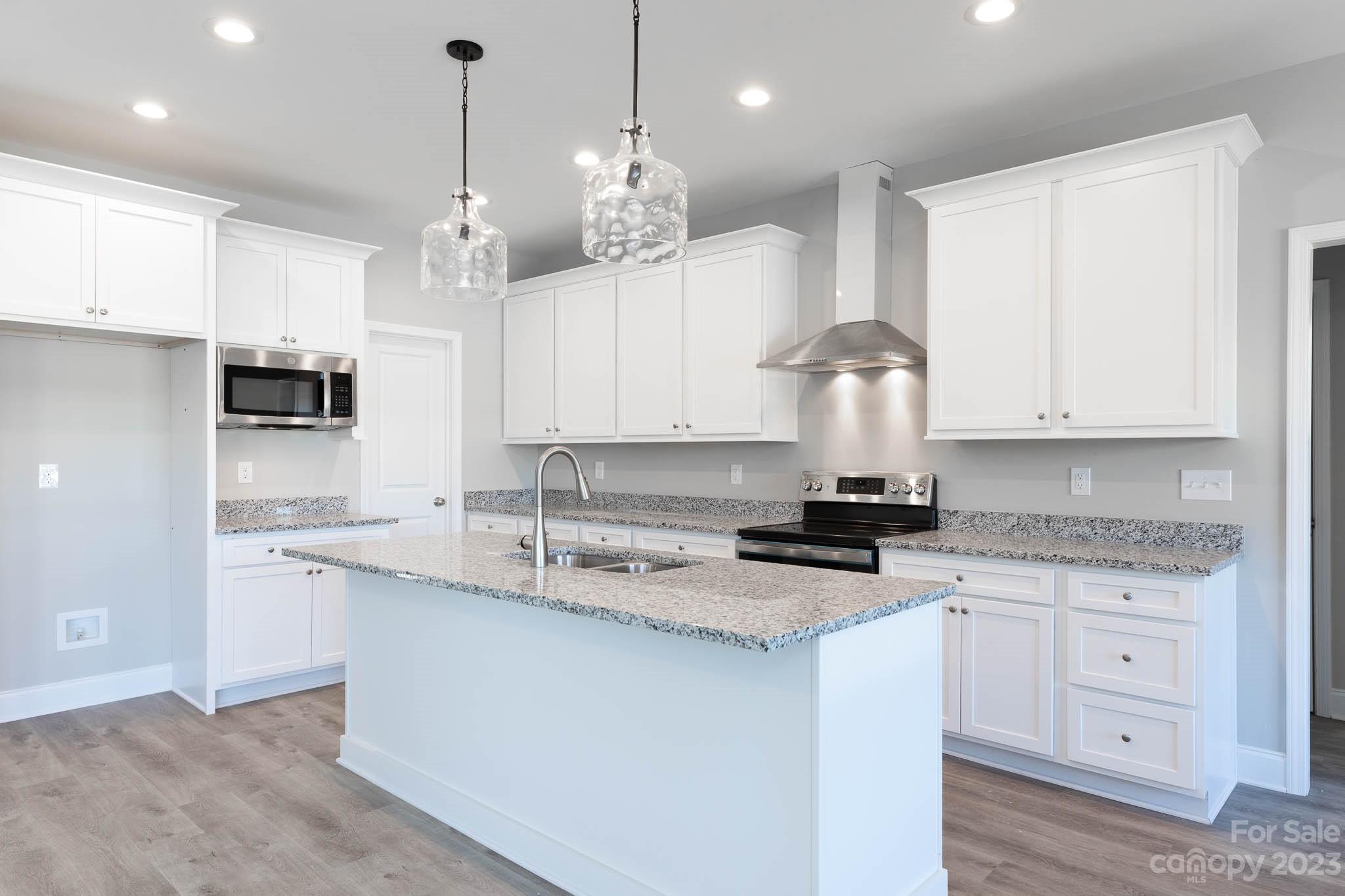 4639 Simpson Road Edgemoor, SC 29712 - Photo 3 of 30 a kitchen with stainless steel appliances granite countertop a sink a stove and a granite counter tops