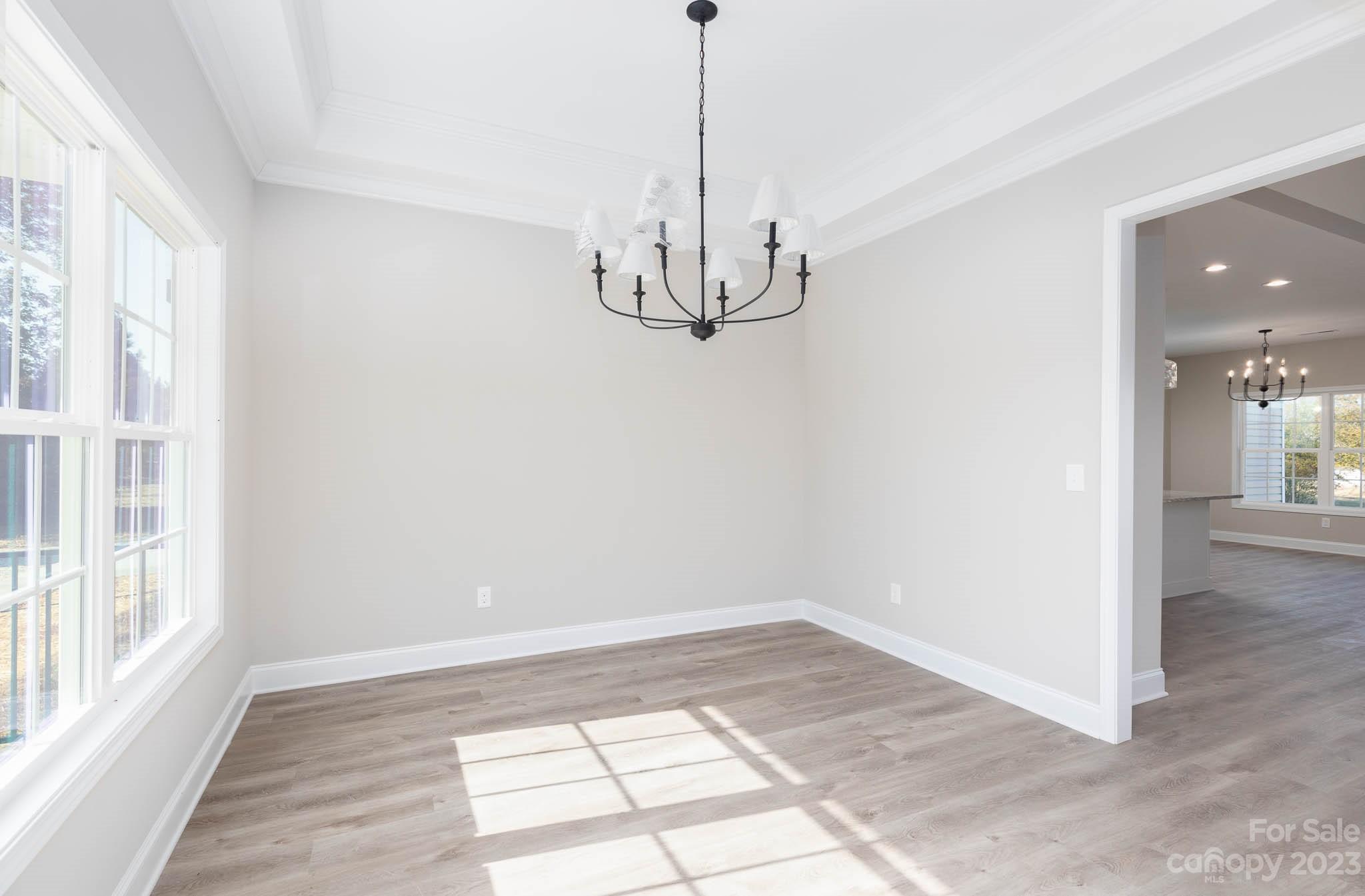 4639 Simpson Road Edgemoor, SC 29712 - Photo 7 of 30 a view of an empty room with wooden floor and windows