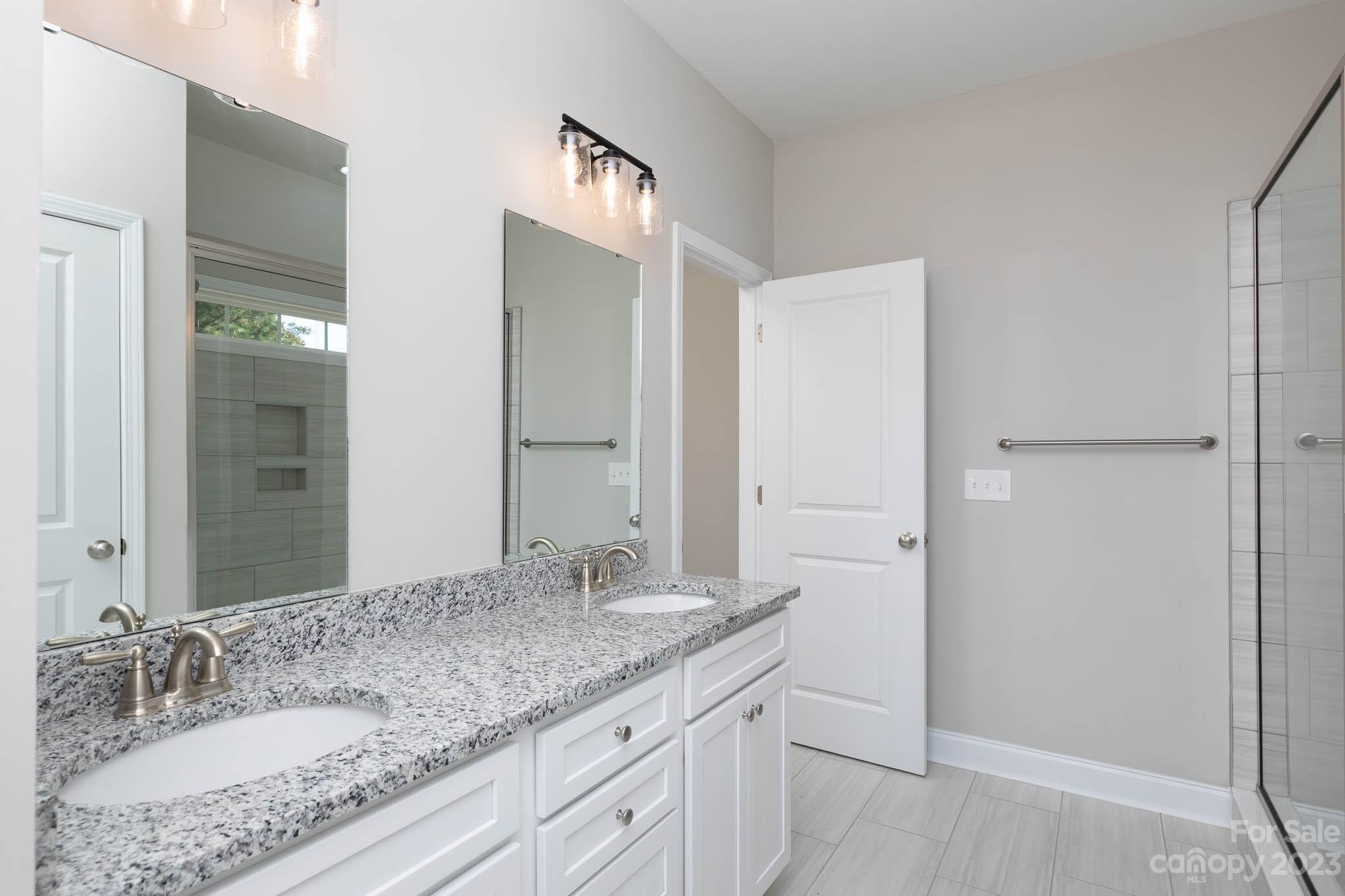 4639 Simpson Road Edgemoor, SC 29712 - Photo 10 of 30 a bathroom with a granite countertop sink and a mirror