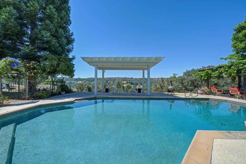 7630 Ridge Road Newcastle, CA 95658 - Photo 61 of 85 Resort-style built-in pool with multiple covered outdoor entertaining areas. Expansive poolside pavilion. Shaded outdoor lounge area. Panoramic valley, hills and pasture views. Incredible sunset views.