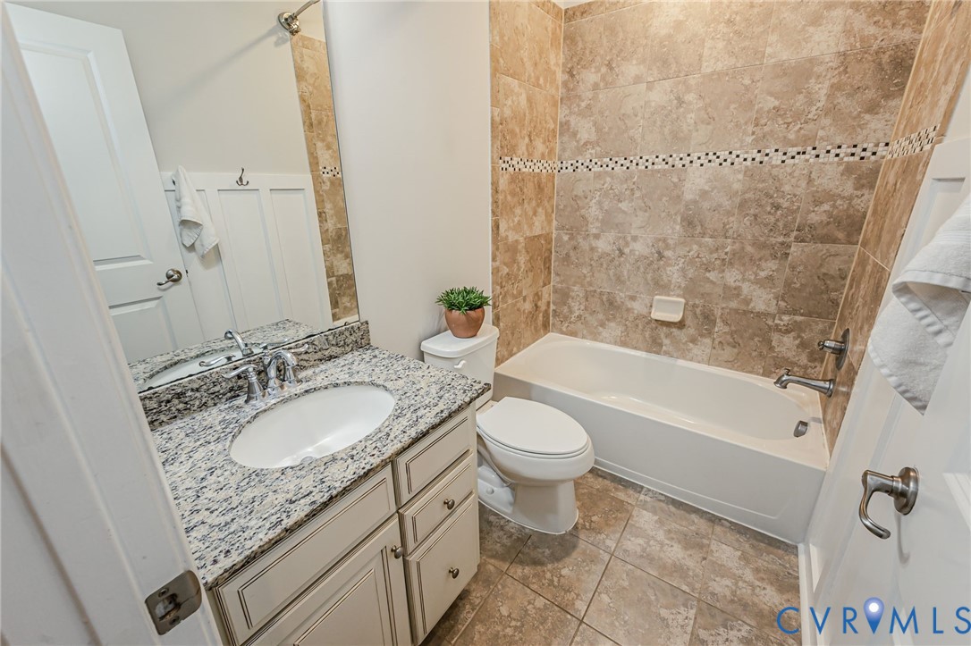 7435 Wicks Road Williamsburg, VA 23188 - Photo 55 of 82 Hall Bathroom featuring a vanity with a white oval