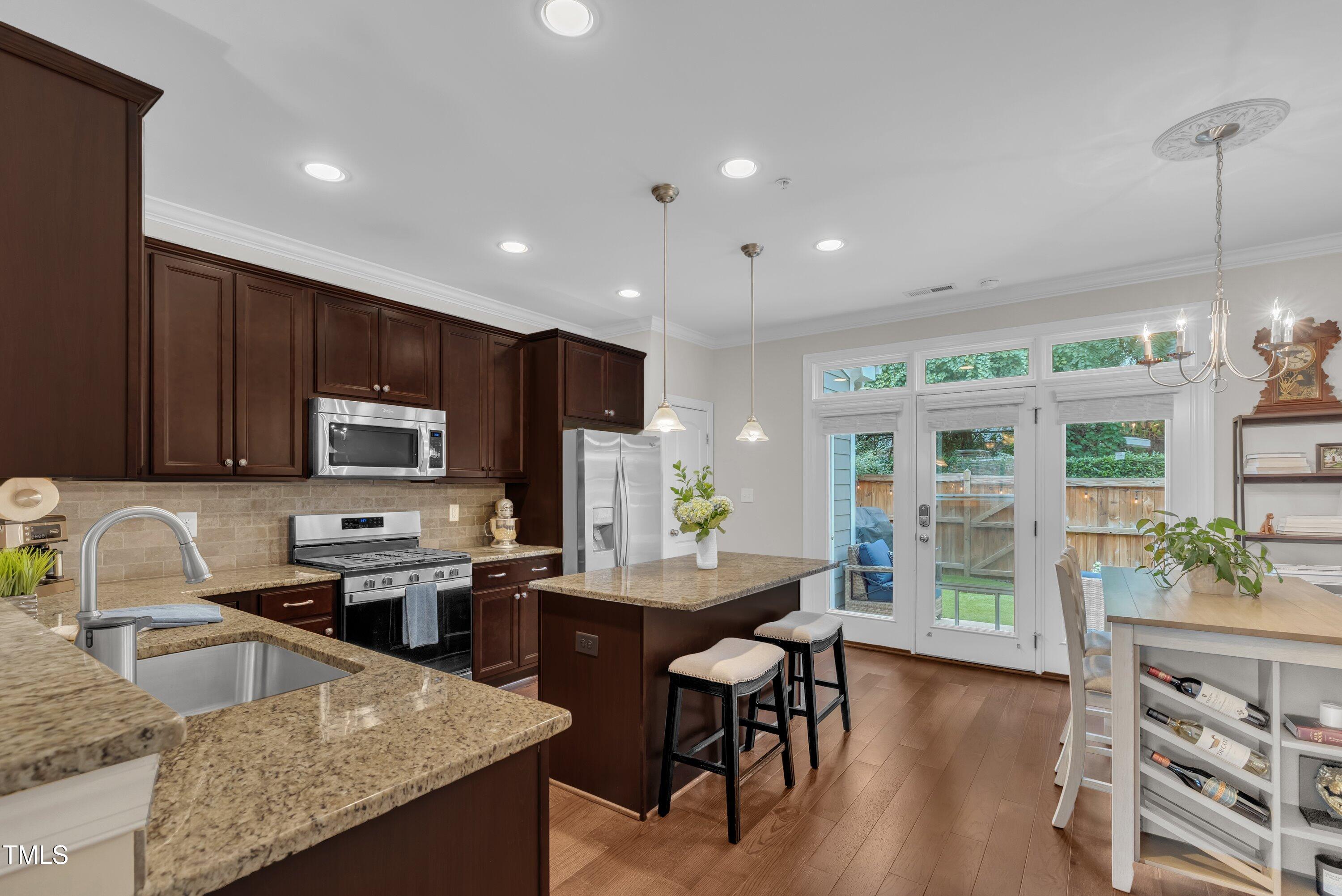 540 Ledbetter Court Raleigh, NC 27608 - Photo 13 of 40 a kitchen with stainless steel appliances granite countertop sink stove top oven and cabinets