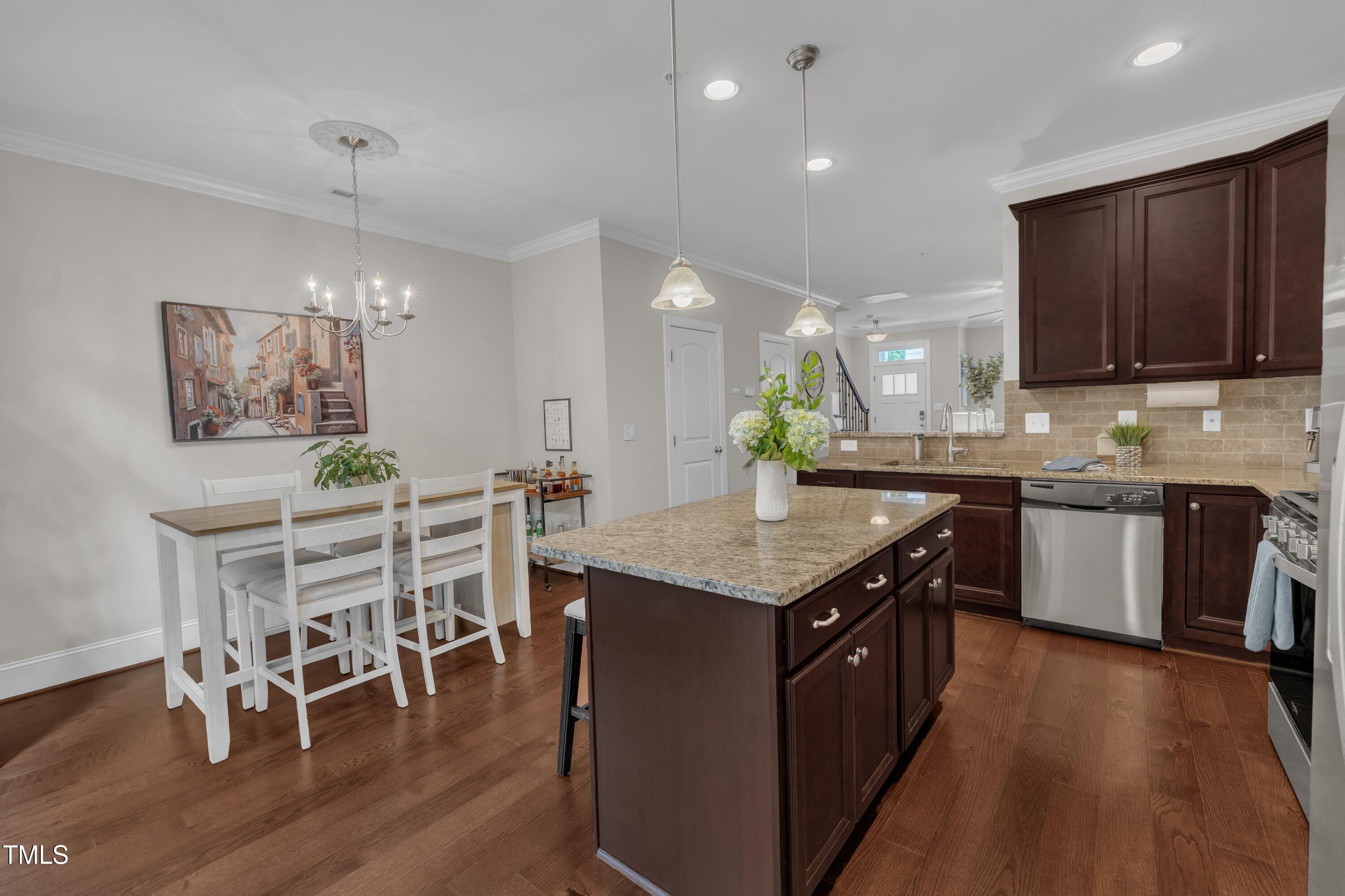 540 Ledbetter Court Raleigh, NC 27608 - Photo 18 of 40 a kitchen with stainless steel appliances granite countertop wooden cabinets a sink a stove a kitchen island and chairs