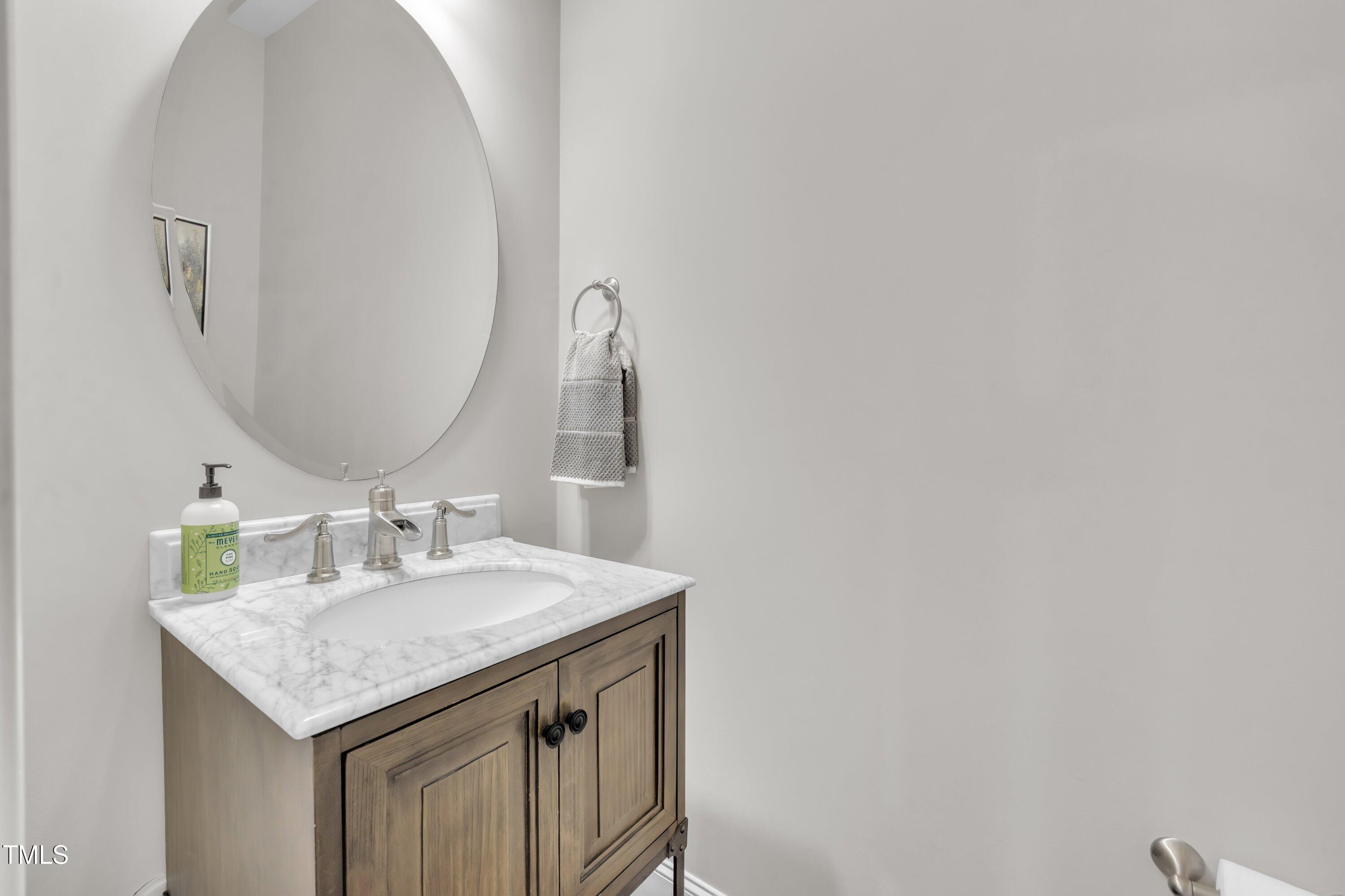 540 Ledbetter Court Raleigh, NC 27608 - Photo 20 of 40 a bathroom with a granite countertop sink and a mirror