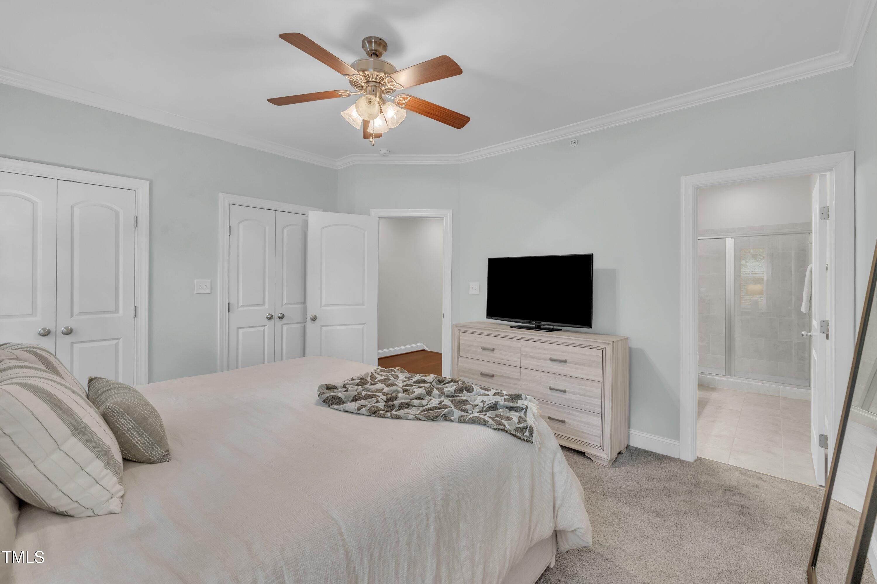 540 Ledbetter Court Raleigh, NC 27608 - Photo 26 of 40 a bedroom with a bed and a flat screen tv