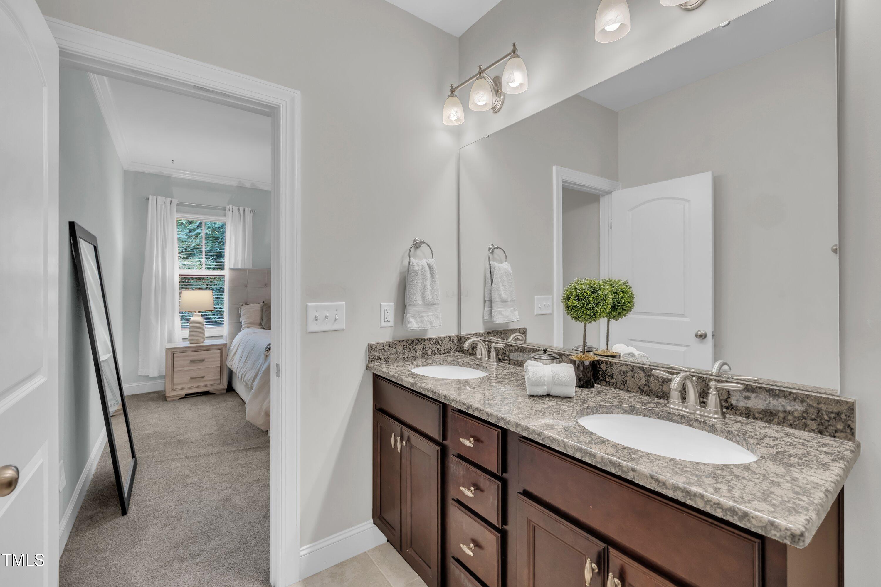 540 Ledbetter Court Raleigh, NC 27608 - Photo 28 of 40 a bathroom with a granite countertop sink and a mirror