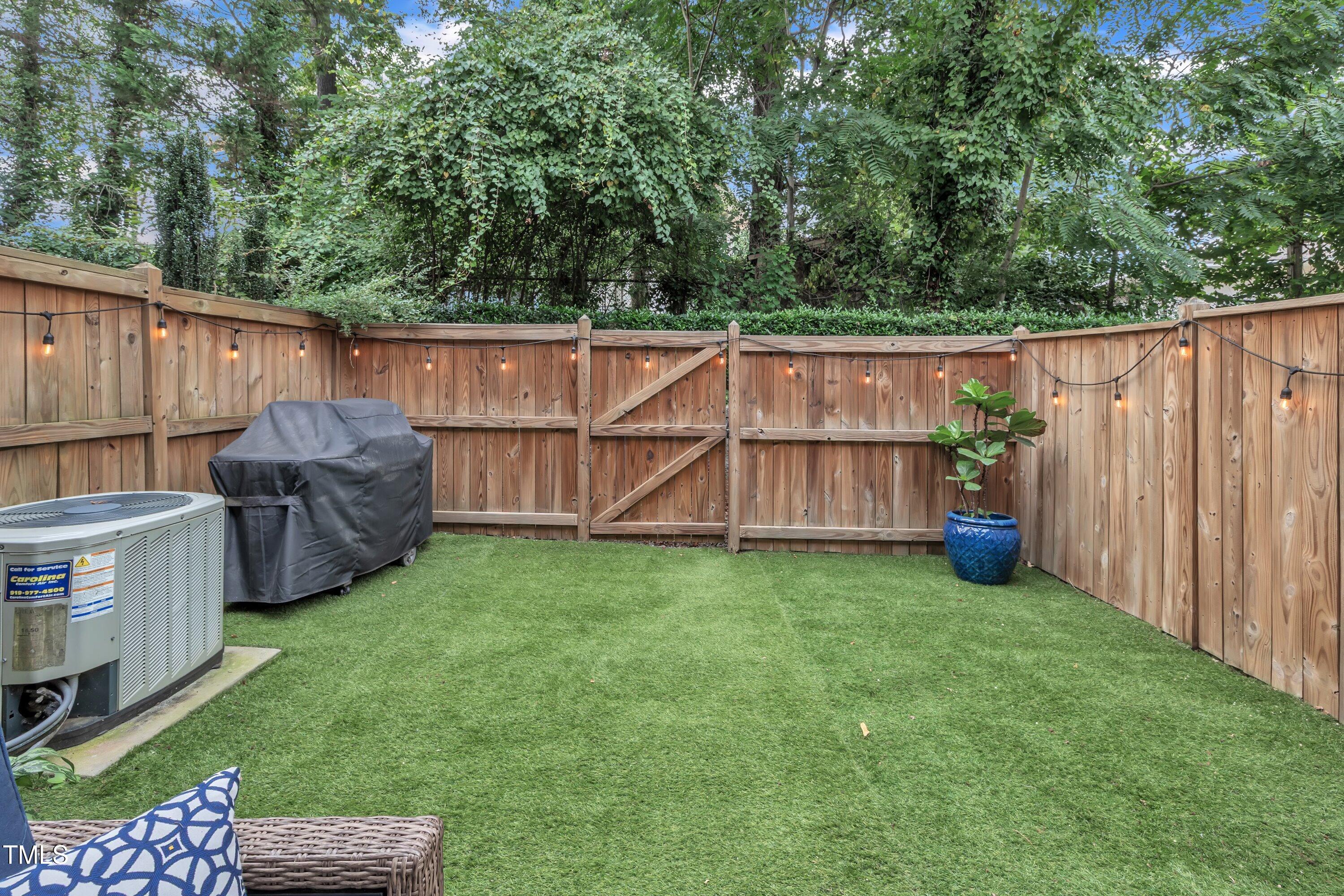 540 Ledbetter Court Raleigh, NC 27608 - Photo 34 of 40 a view of a backyard with wooden fence and large trees
