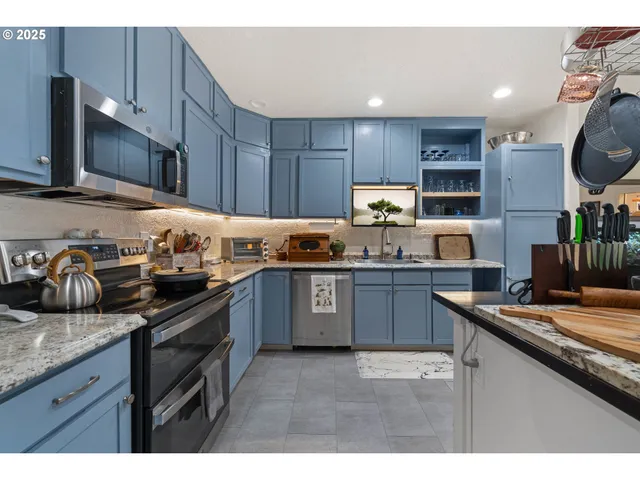 a kitchen with a sink stove top oven and microwave