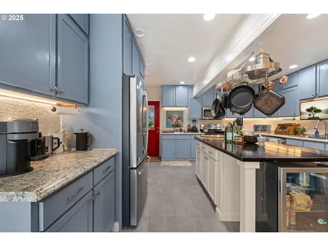 a kitchen with stainless steel appliances granite countertop a sink and stove