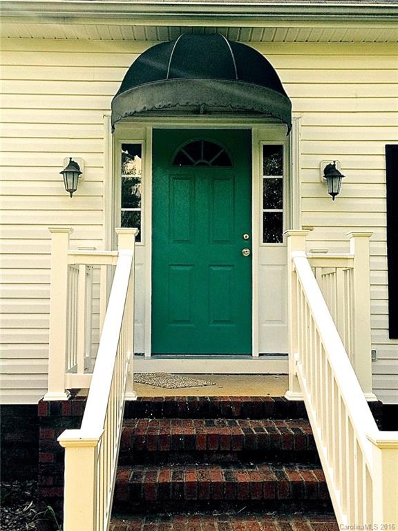 49487 Quail Trail Road Norwood, NC 28128 - Photo 2 of 24 a view of a entryway door of the house with a yard