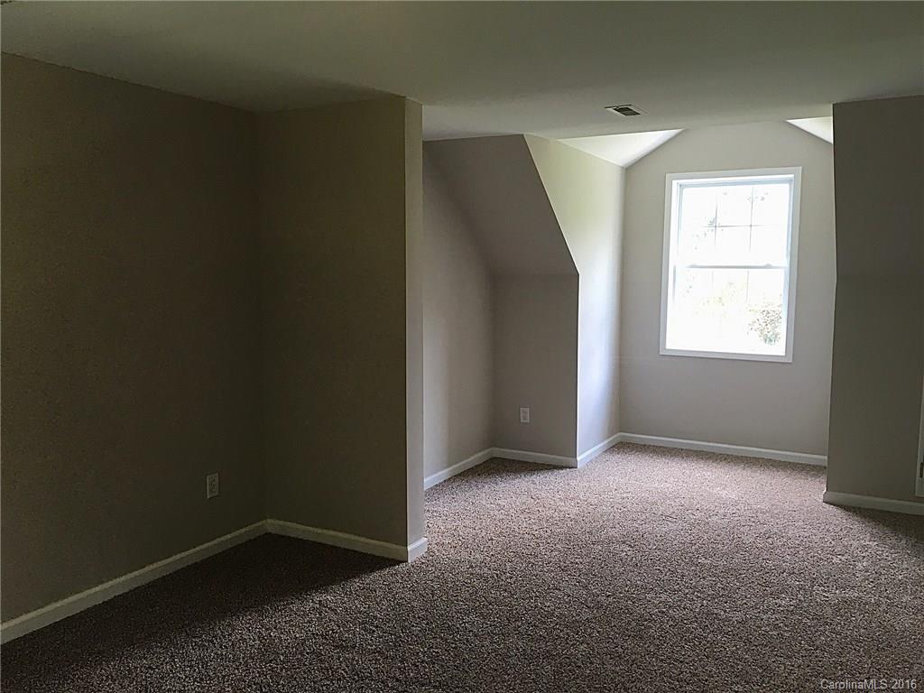 49487 Quail Trail Road Norwood, NC 28128 - Photo 15 of 24 an empty room with windows