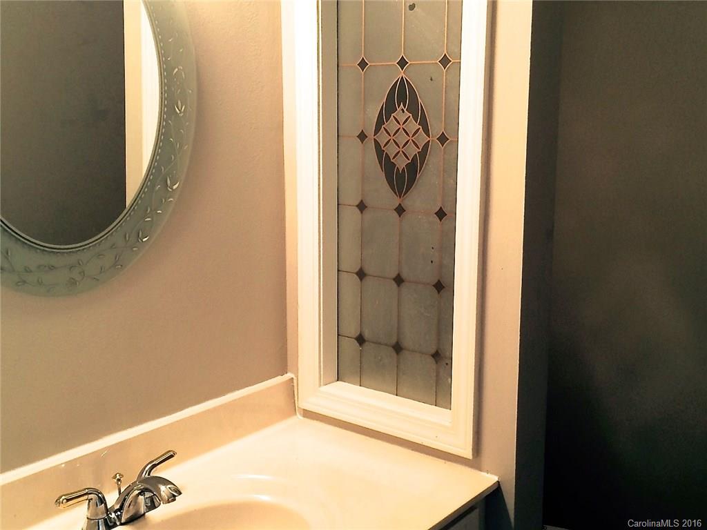 49487 Quail Trail Road Norwood, NC 28128 - Photo 18 of 24 a bathroom with a shower and mirror