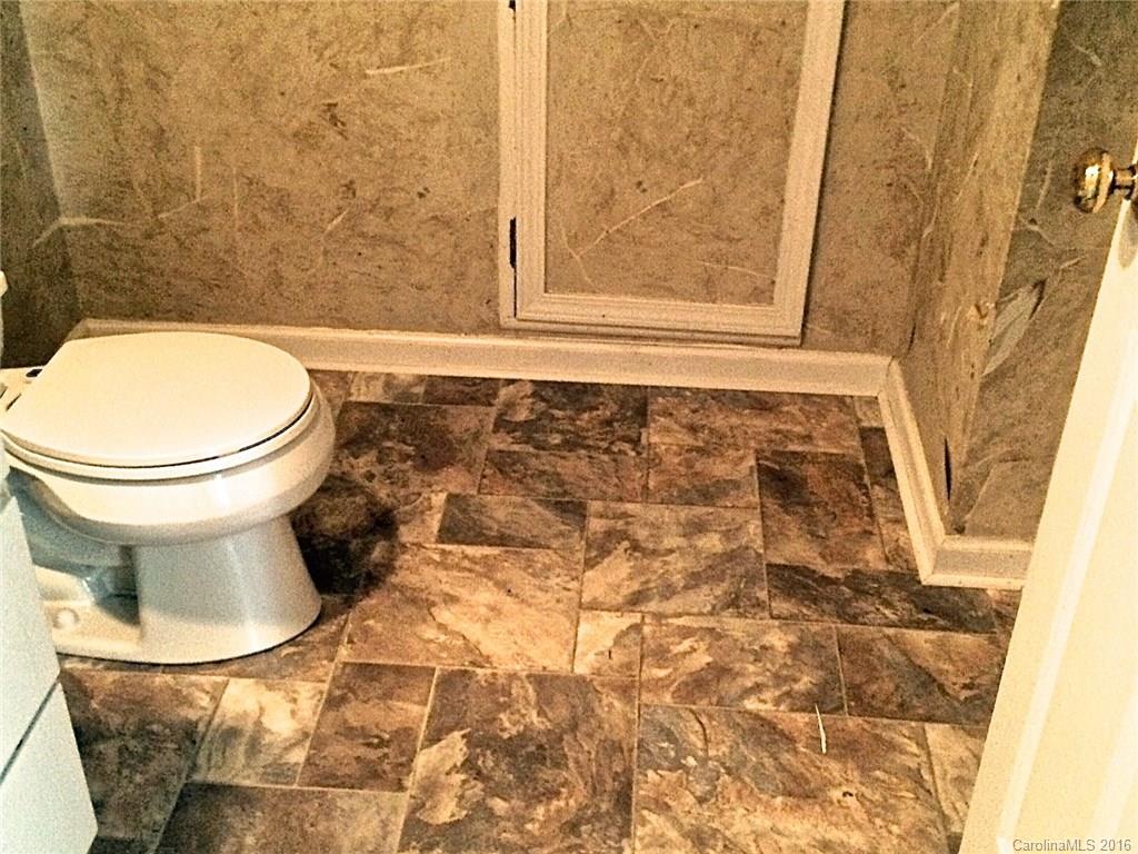 49487 Quail Trail Road Norwood, NC 28128 - Photo 19 of 24 a bathroom with a toilet and a shower