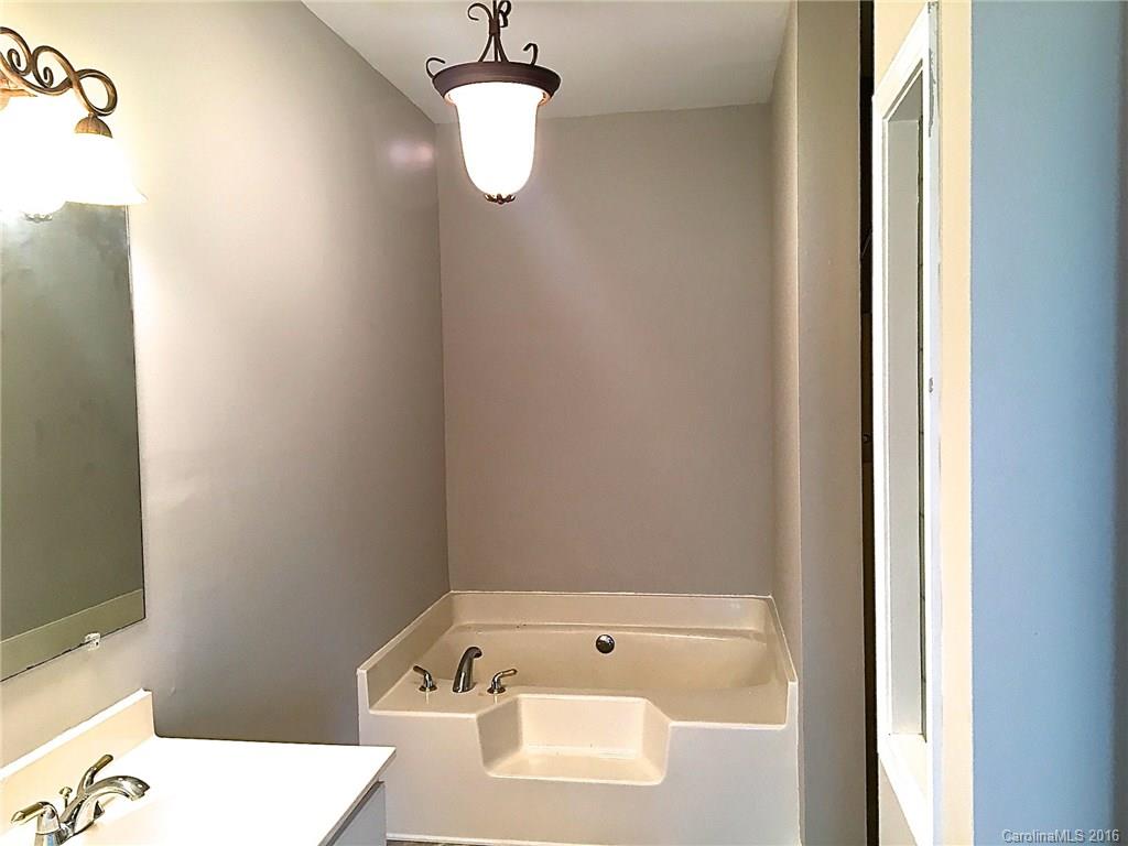 49487 Quail Trail Road Norwood, NC 28128 - Photo 20 of 24 a bathroom with a bathtub and a sink