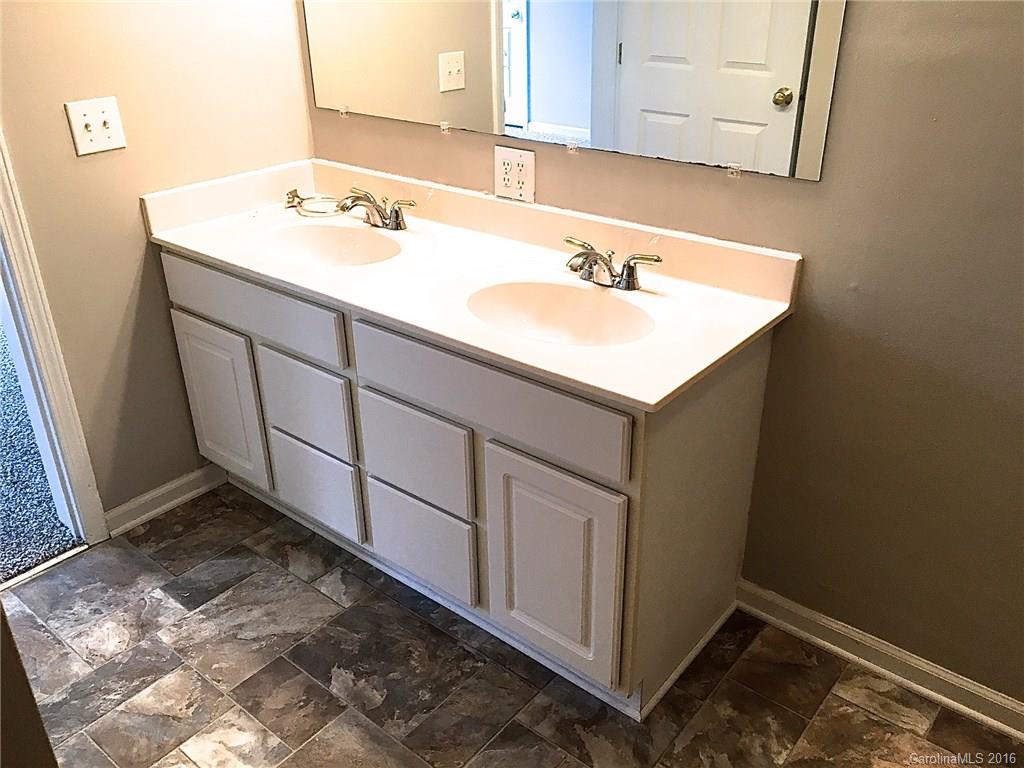 49487 Quail Trail Road Norwood, NC 28128 - Photo 21 of 24 a bathroom with a sink and a mirror