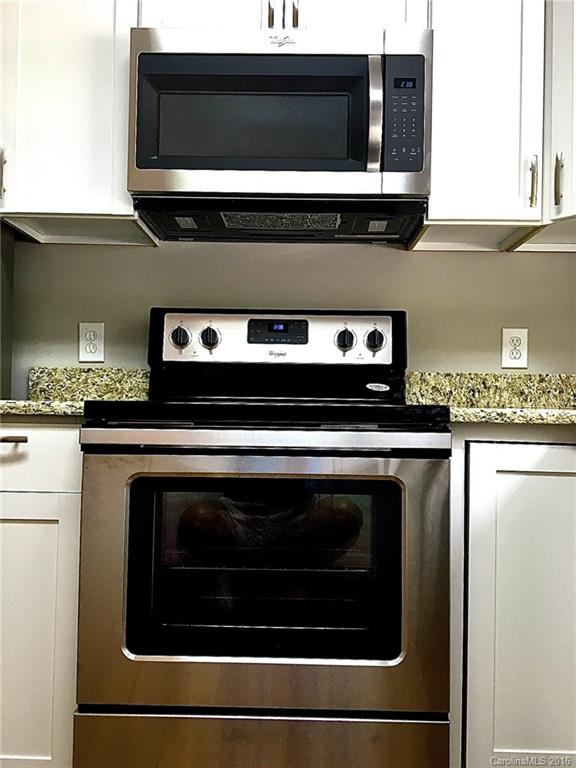 49487 Quail Trail Road Norwood, NC 28128 - Photo 6 of 24 a stove top oven sitting inside of a kitchen