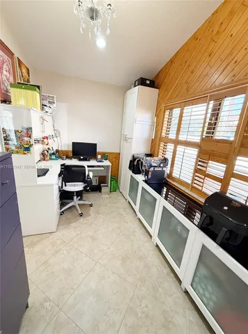 a view of a livingroom with workspace and a window