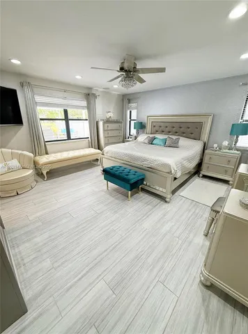 a bedroom with bed and wooden floor