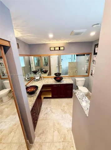 a bedroom with a bed and a mirror