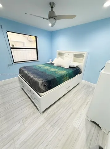 a living room with a couch and a dresser next to a window