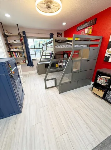 a bathroom with a granite countertop sink a mirror and a bathtub