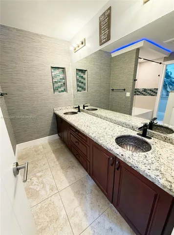 a bathroom with a tub sink and a shower