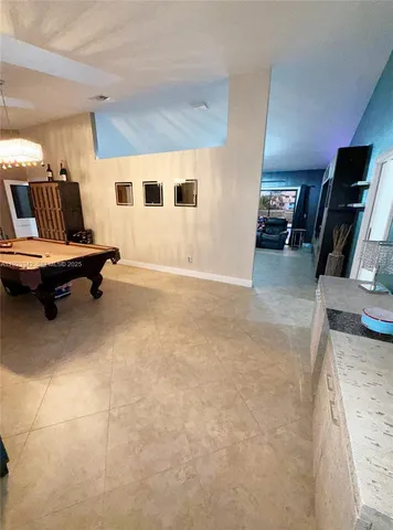 a living room with furniture gym equipment and a flat screen tv