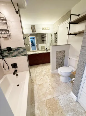 a view of swimming pool with outdoor seating and plants