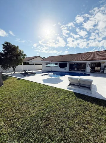 a view of house with yard and ocean view