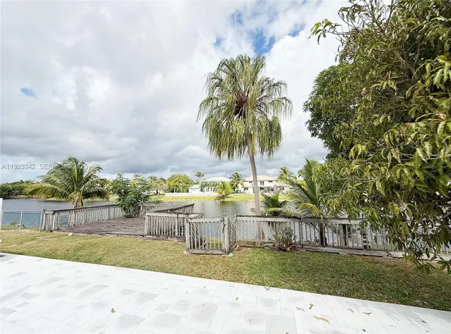 a view of a yard with large trees