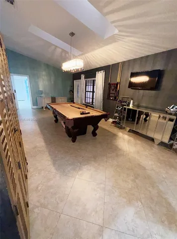 a spacious bedroom with a bed and a flat screen tv