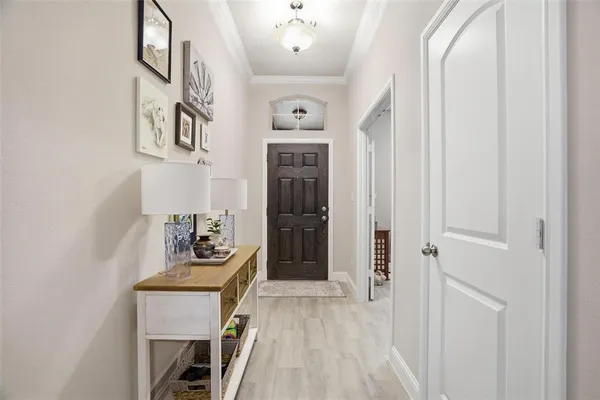 a view of a hallway with wooden floor and dining room