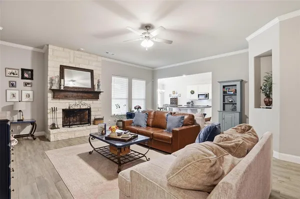 a living room with furniture a fireplace and window