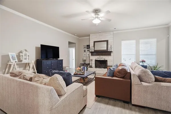a living room with furniture a fireplace and a flat screen tv