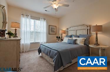 200 Reserve Boulevard, Unit B Charlottesville, VA 22901 - Photo 11 of 13 a bed room with a bed and a chandelier