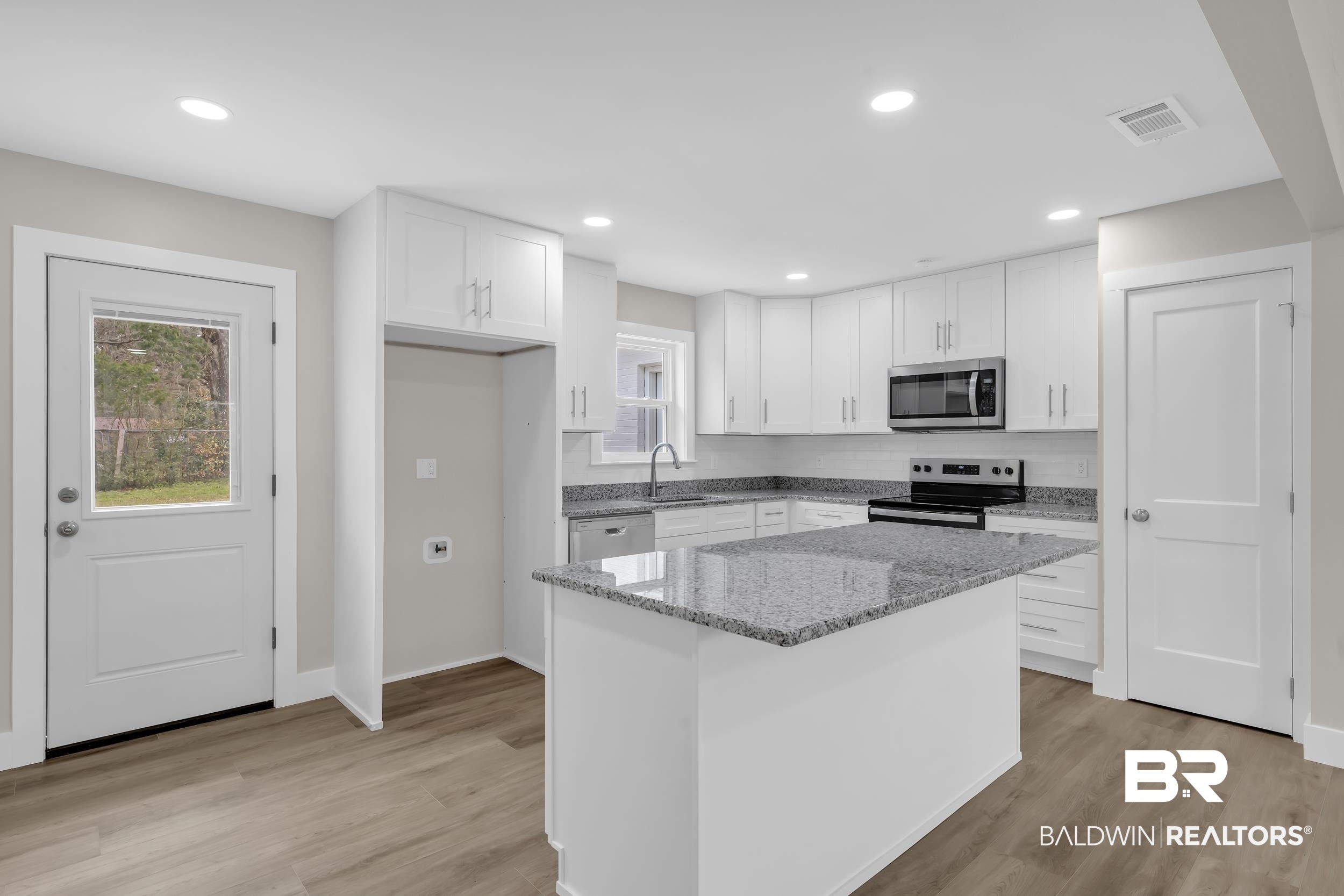 11381 Normandy Drive East Semmes, AL 36575 - Photo 7 of 23 Kitchen with white cabinets, light stone countertops, stainless steel appliances, light wood-style floors, and recessed lighting
