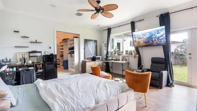 a living room with furniture and a wooden floor