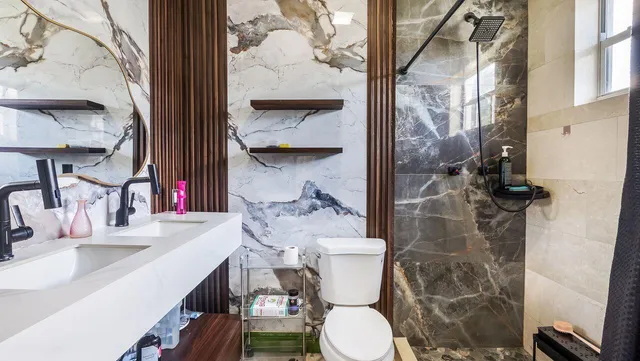 a bathroom with a sink and mirror with bathtub