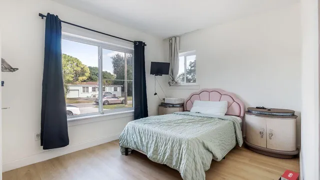 a bedroom with a bed and a window