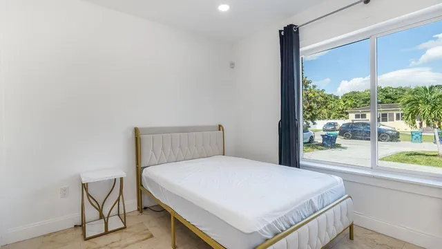 a bedroom with a bed and a window