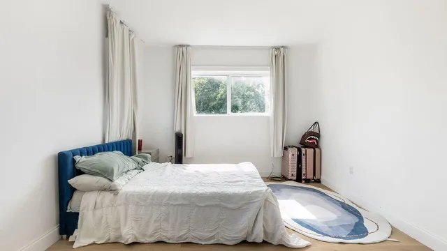 a bedroom with a bed and a window