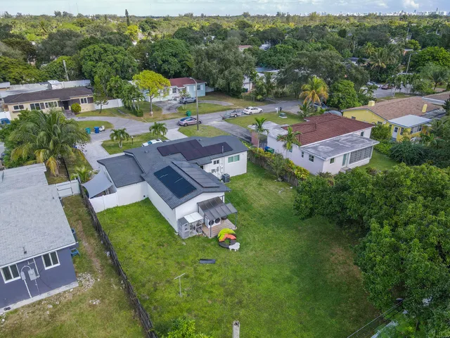 an aerial view of multiple houses with yard
