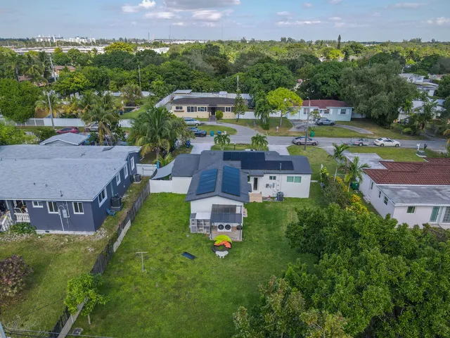 an aerial view of a house with a garden and mountain view