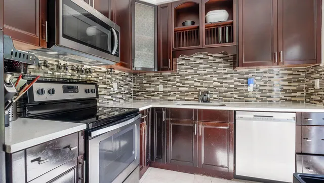 a kitchen with granite countertop a sink and a stove
