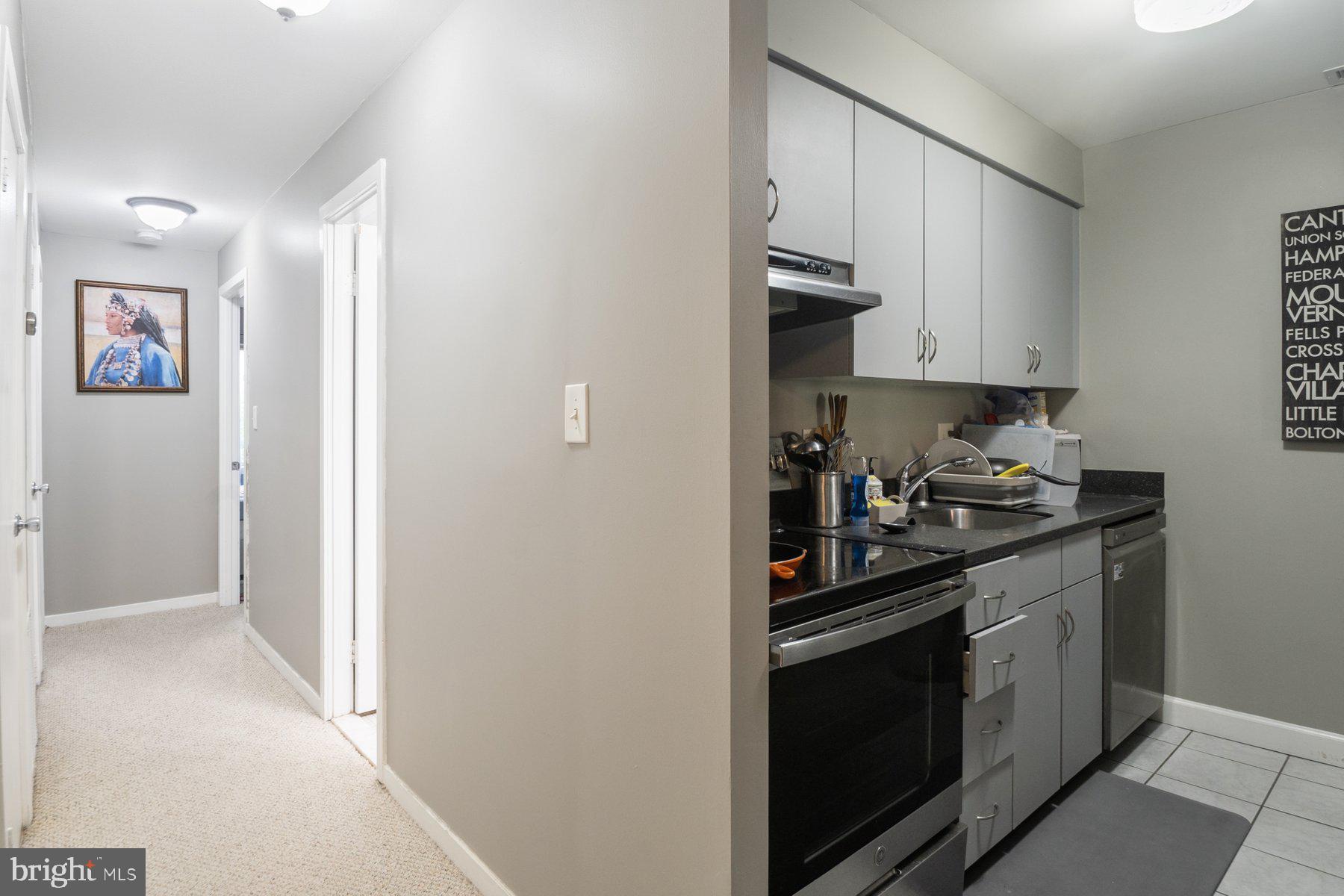 642 South Charles Street, Unit R 22 Baltimore, MD 21230 - Photo 8 of 26 a kitchen with stainless steel appliances granite countertop a stove and a refrigerator